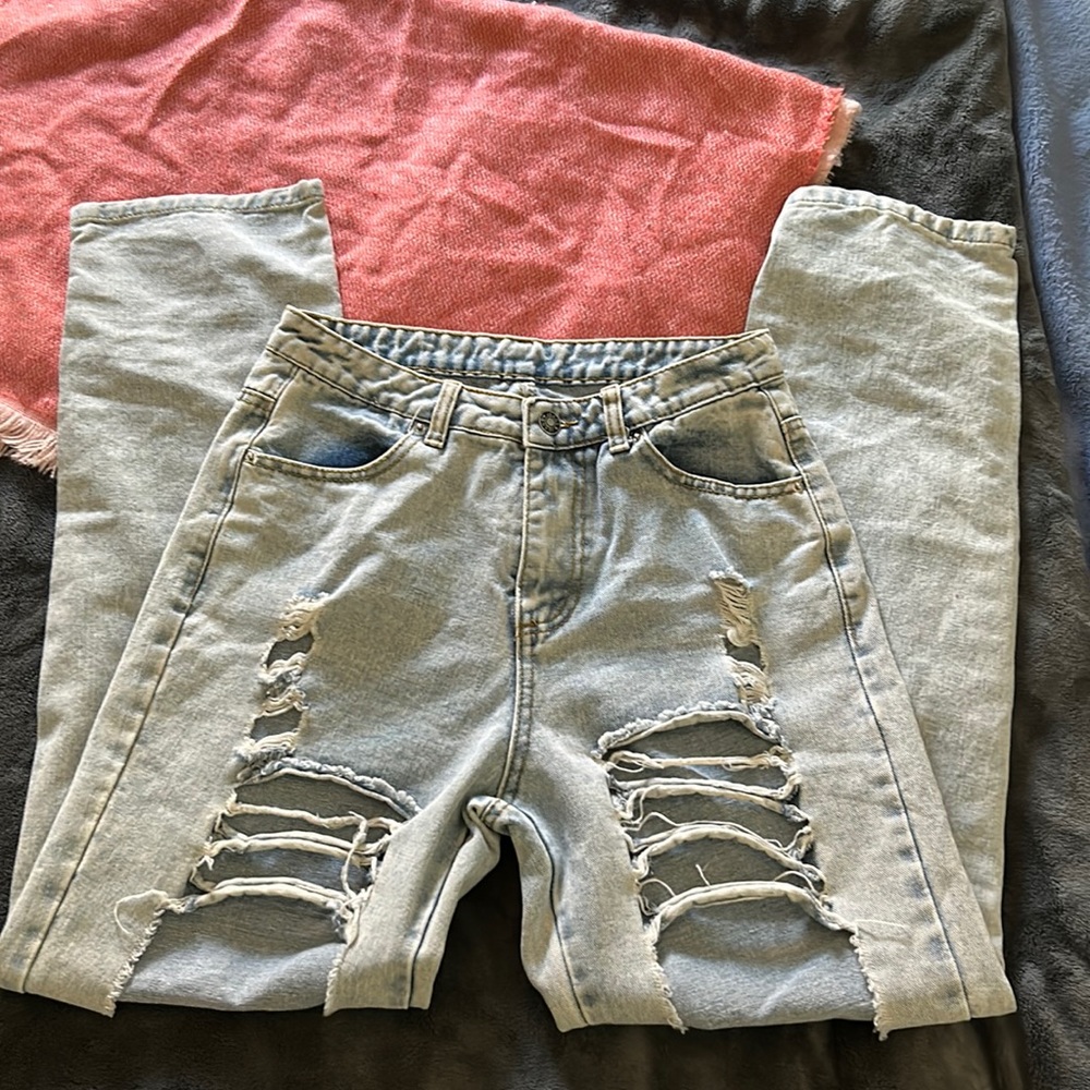 Worn. bleach washed ripped jeans. smaller waist compared to leg with.